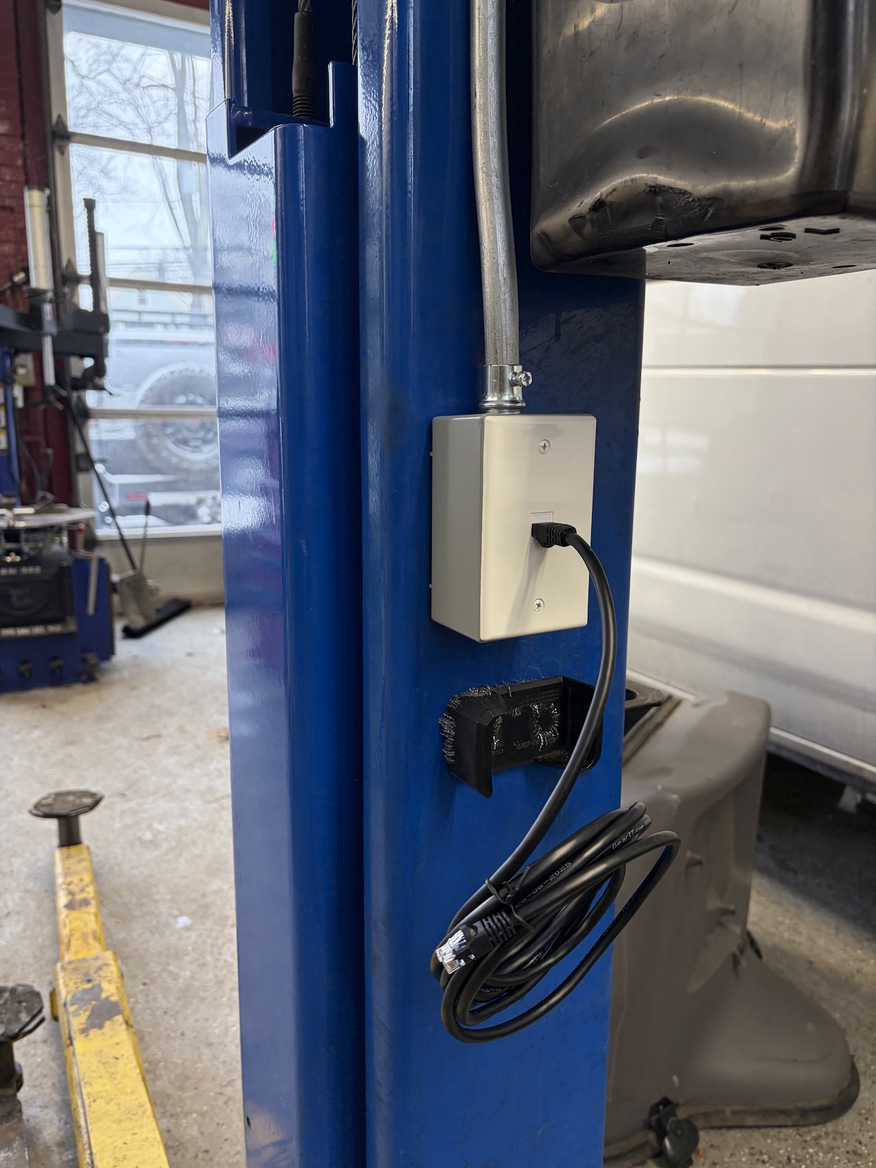Ethernet ports installed at automotive lift stations enabling mechanics to perform vehicle software updates and access remote technical support.