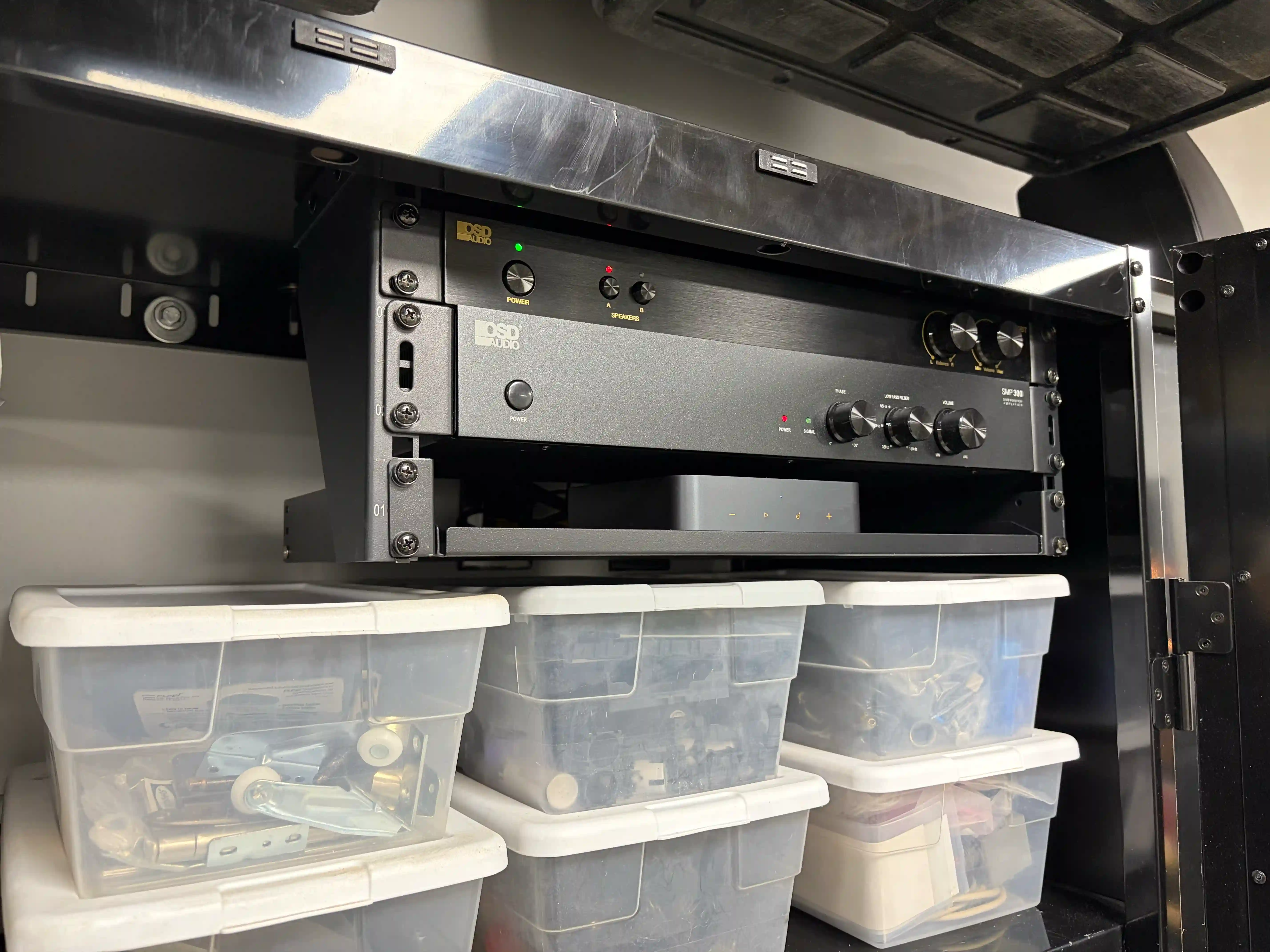 Garage audio system with rack-mounted equipment installed inside a storage cabinet in Miller Place, NY.