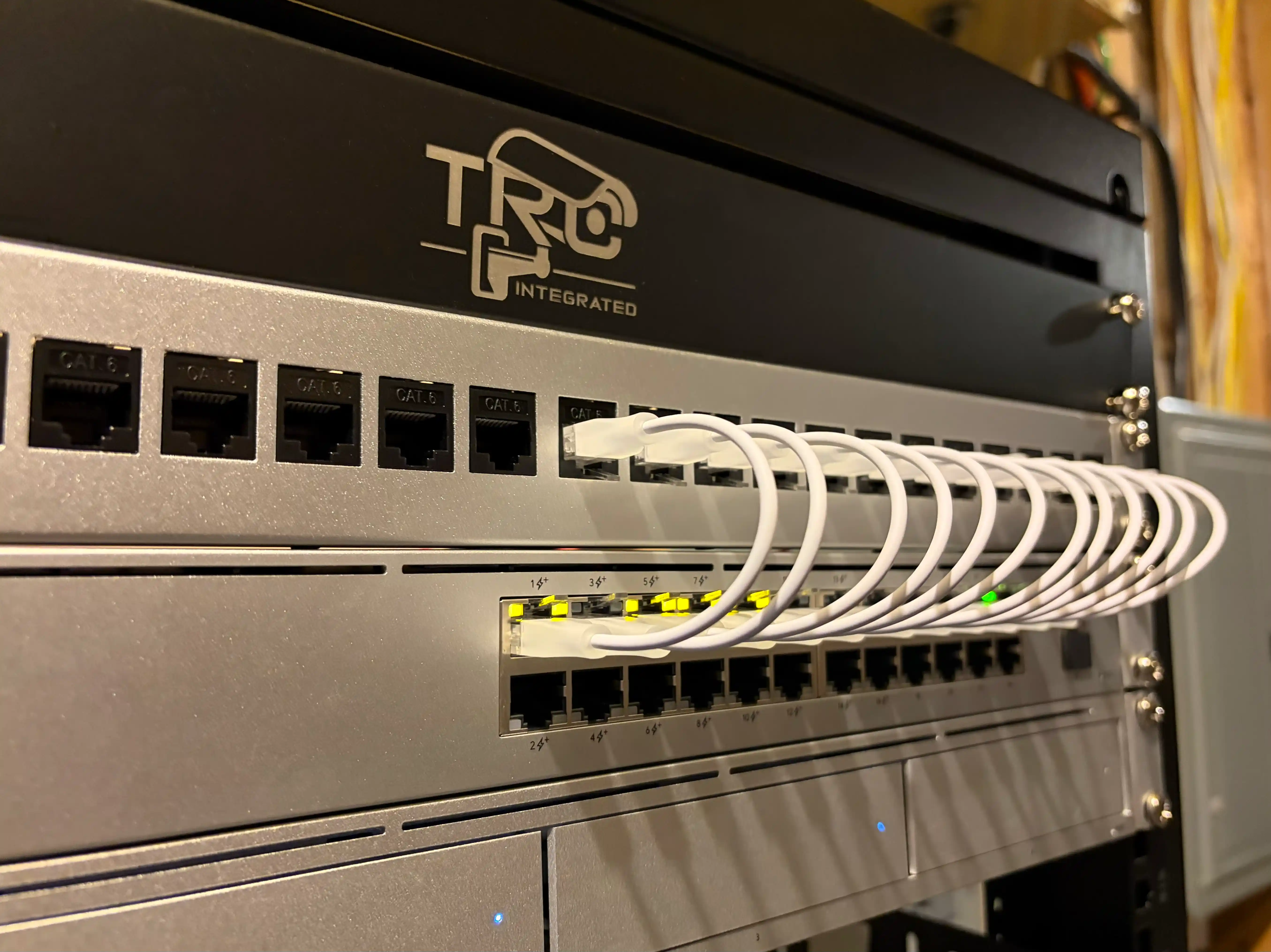 Network rack with UniFi switch, UNVR, and clean cabling.